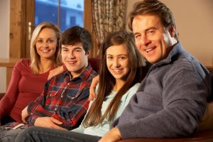 family-sitting-together-smiling